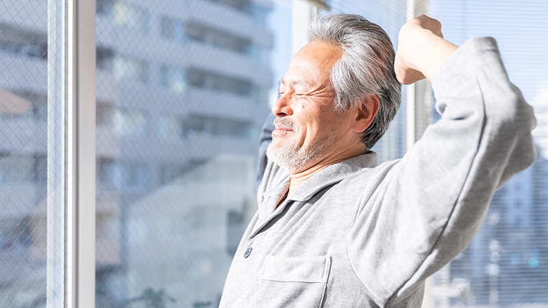 朝日を浴びてやる気が漲っている高齢者男性